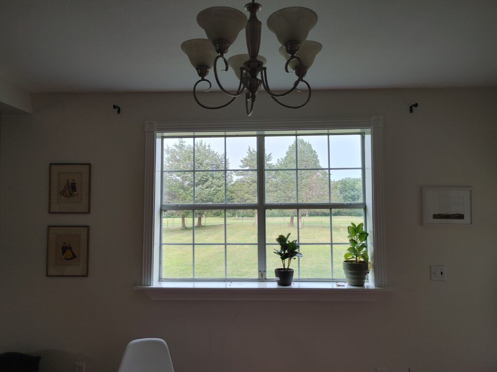 Bare window looking into a neighboring field