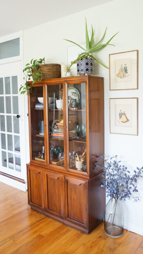 China cabinet with plants on top